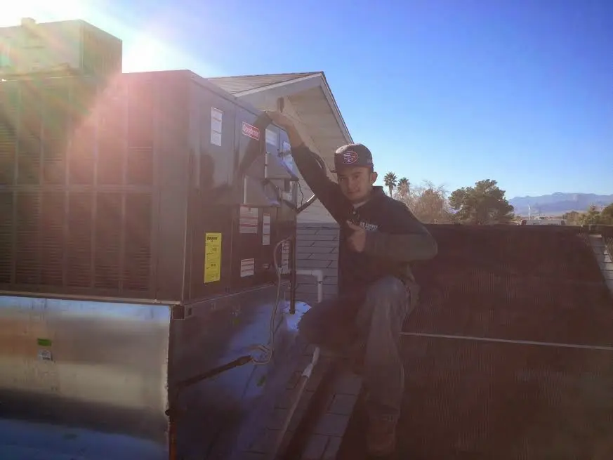 HVAC technician performing HVAC Inspection on a rooftop unit in McAlester